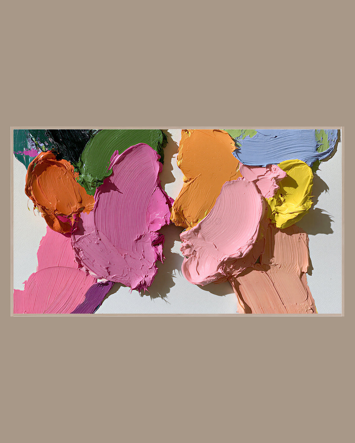 Abstract Frame TV Art of thick, glossy strokes of pink, peach, mustard, olive and lilac paint layered across a pale background, in a light wood frame on a warm taupe wall