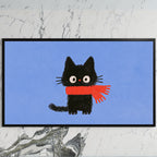 Black kitten in a scarf art on a black TV on a white marble wall