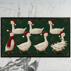 Geese in Santa hats art on a black TV on a white marble wall