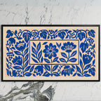 Blue paper cut flowers art on a black TV on a white marble wall