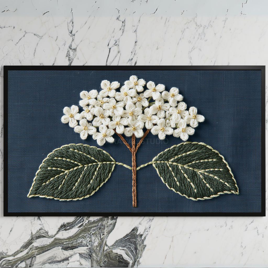Embroidered hydrangea art on a black TV on a white marble wall