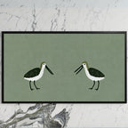 Two shorebirds art on a black TV on a white marble wall
