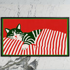 Sleeping cat and candy cane stripes art on a black TV on a white marble wall