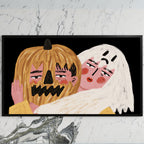 Jack-o'-lantern and ghost art on a black TV on a white marble wall