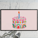 Rainbow birthday cake art on a black TV on a white marble wall