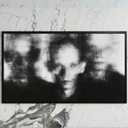 Blurred faces art on a black TV on a white marble wall