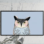Grumpy owl art on a black TV on a white marble wall