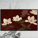 Cream blossoms on burgundy art on a black TV on a white marble wall