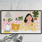 Woman at a pink table art on a black TV on a white marble wall