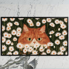 Ginger cat in daisies art on a black TV on a white marble wall