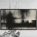 Black and white abstract art on a black TV on a white marble wall