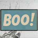 Retro Boo art on a black TV on a white marble wall
