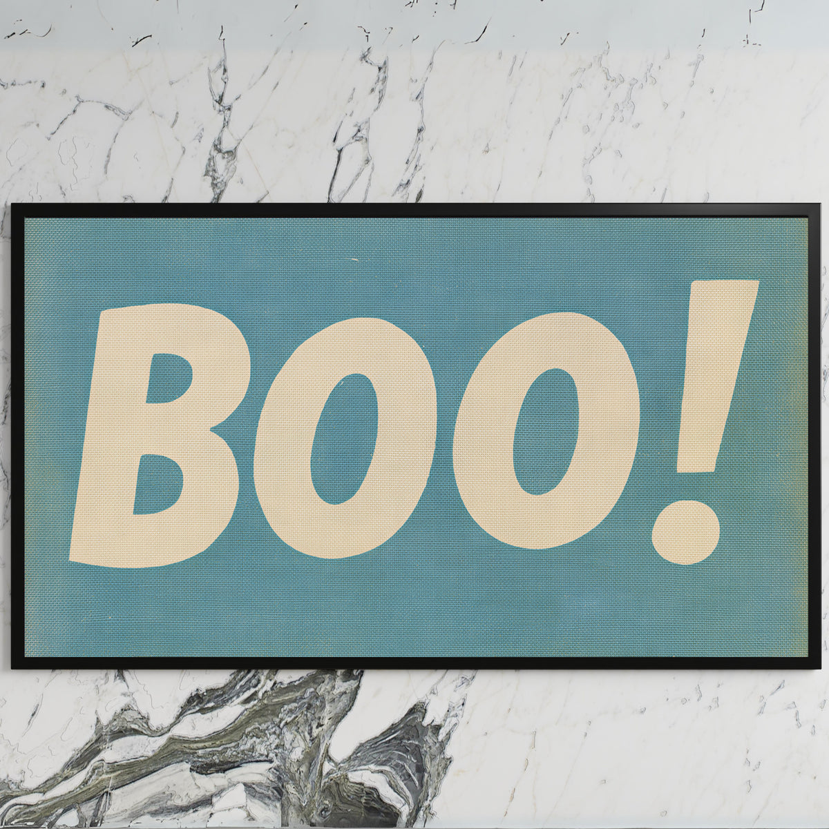 Retro Boo art on a black TV on a white marble wall
