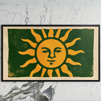 Woodblock sun art on a black TV on a white marble wall