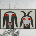 Folk art goats art on a black TV on a white marble wall