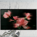 Ribbed glass flowers art on a black TV on a white marble wall