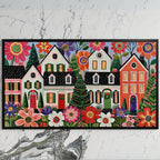 Folk art Christmas village art on a black TV on a white marble wall