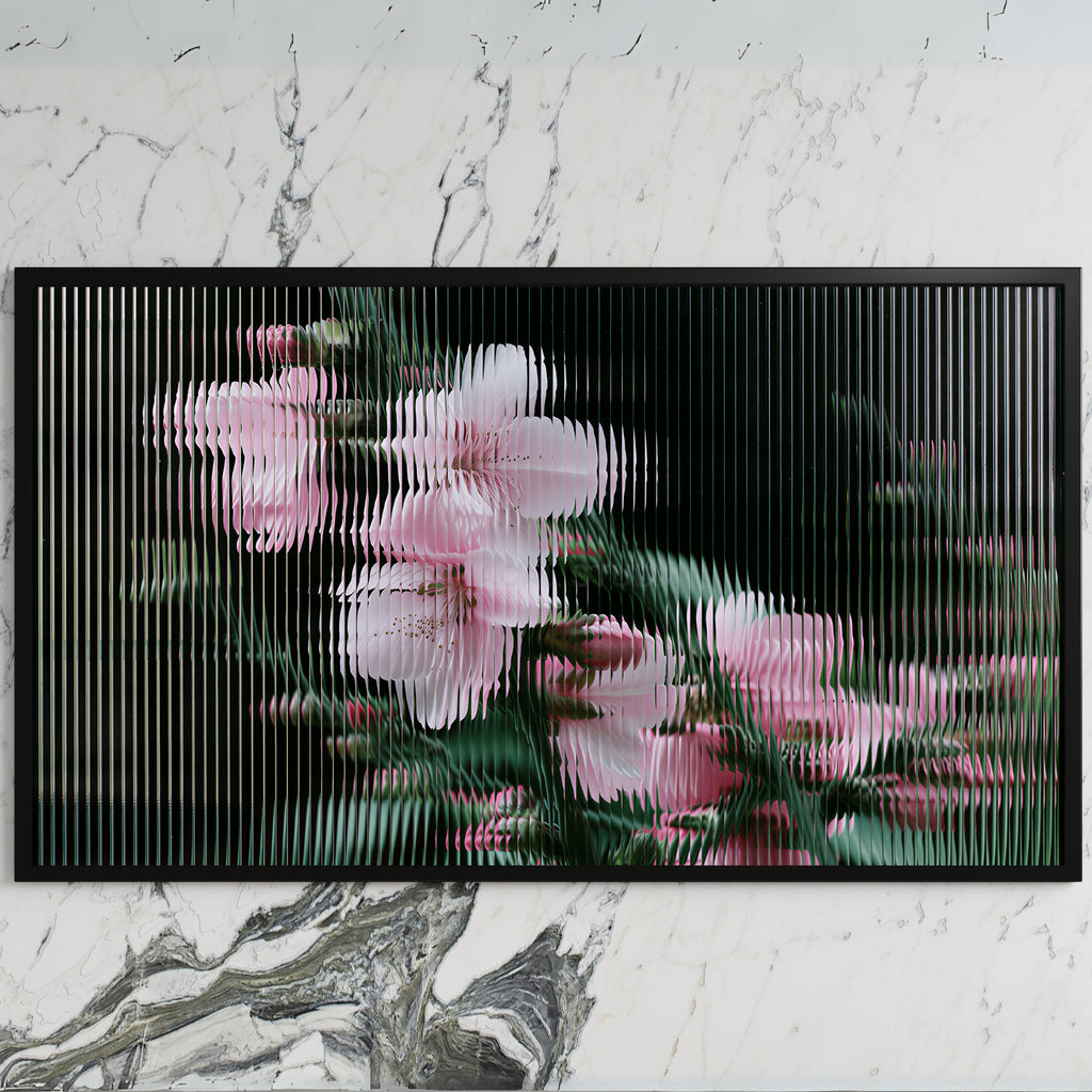 Fluted glass blossom art on a black TV on a white marble wall