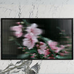 Fluted glass blossom art on a black TV on a white marble wall