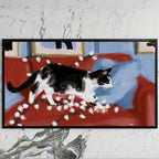 Black and white cat with Christmas lights art on a black TV on a white marble wall