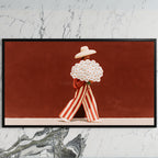 Figure with a daisy bouquet art on a black TV on a white marble wall