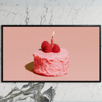 Birthday cake art on a black TV on a white marble wall