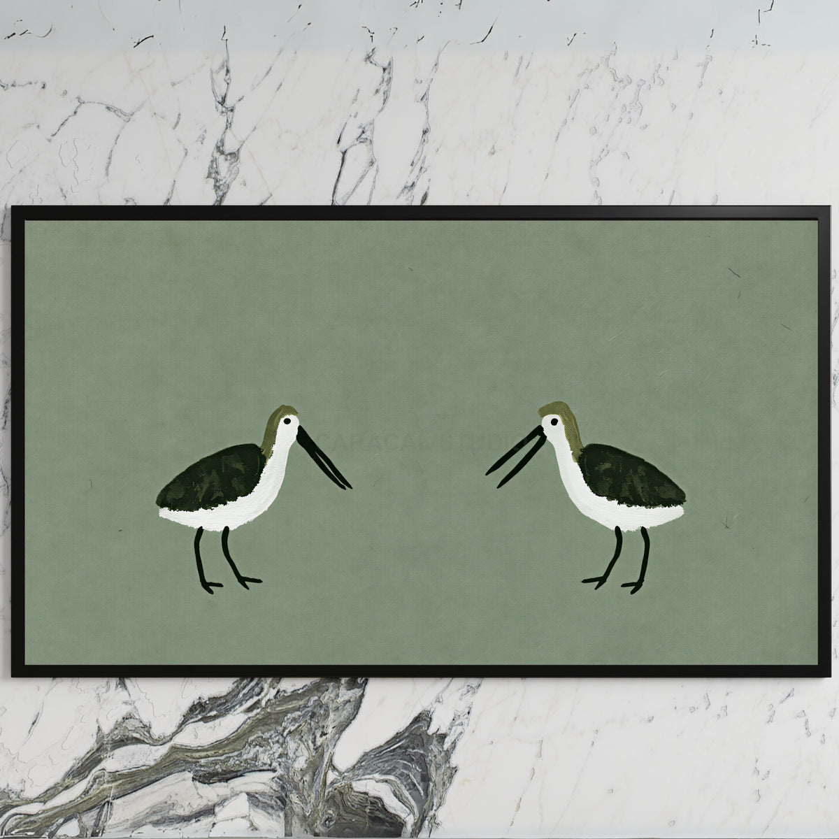 Two shorebirds art on a black TV on a white marble wall