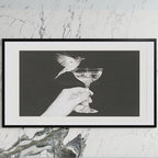 Bird and champagne glass art on a black TV on a white marble wall