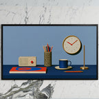 Retro desk, radio and clock art on a black TV on a white marble wall