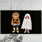 Trick-or-treaters art on a black TV on a white marble wall