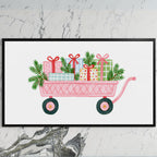 Pink wagon with gifts art on a black TV on a white marble wall