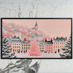 Pink Christmas village art on a black TV on a white marble wall