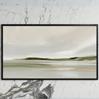 Misty sage shoreline art on a black TV on a white marble wall