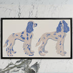 Spaniel figurines art on a black TV on a white marble wall