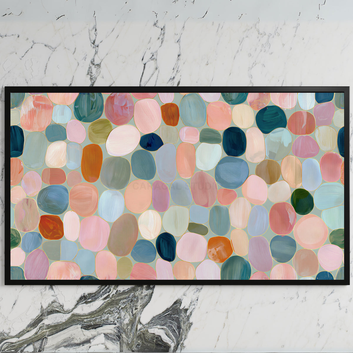 Pastel pebble mosaic art on a black TV on a white marble wall