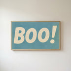 Retro Boo Frame TV art in an oak frame on a warm white wall