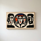 Linocut faces Frame TV art in an oak frame on a warm white wall