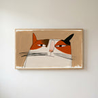 Calico cat face Frame TV art in an oak frame on a warm white wall