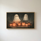 Two ghosts and jack-o'-lanterns Frame TV art in an oak frame on a warm white wall