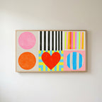 Colorful shapes and heart Frame TV art in an oak frame on a warm white wall