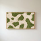 Olive cowhide Frame TV art in an oak frame on a warm white wall