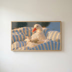 Duck reading in bed Frame TV art in an oak frame on a warm white wall