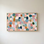 Pastel pebble mosaic Frame TV art in an oak frame on a warm white wall