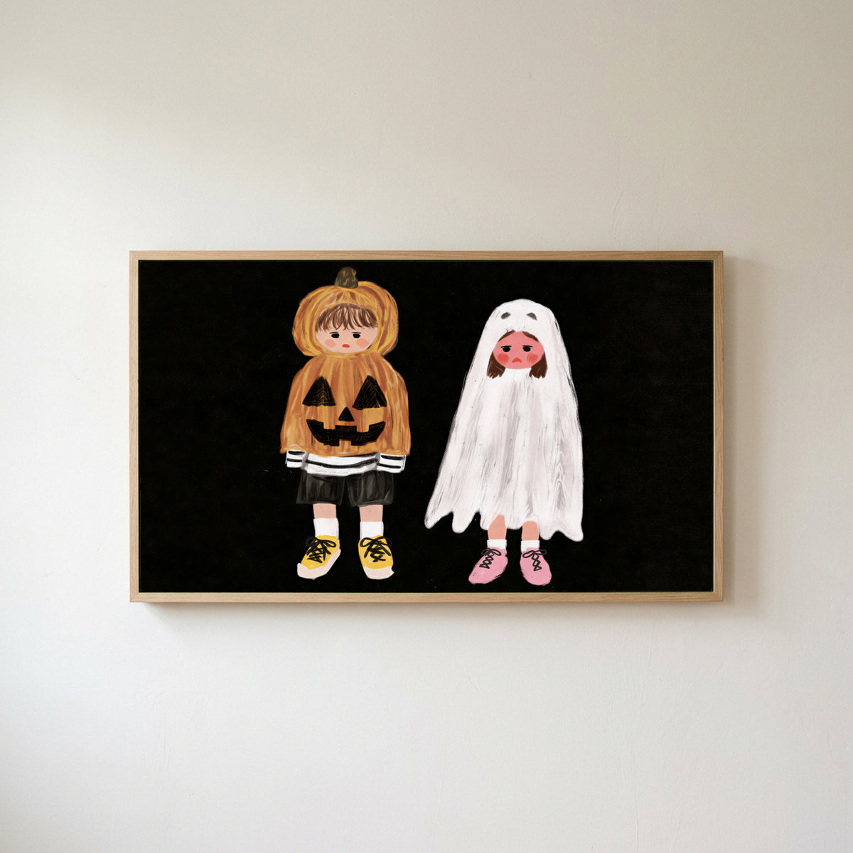 Trick-or-treaters Frame TV art in an oak frame on a warm white wall