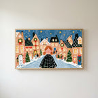 Gingerbread village Frame TV art in an oak frame on a warm white wall