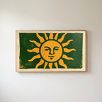 Woodblock sun Frame TV art in an oak frame on a warm white wall