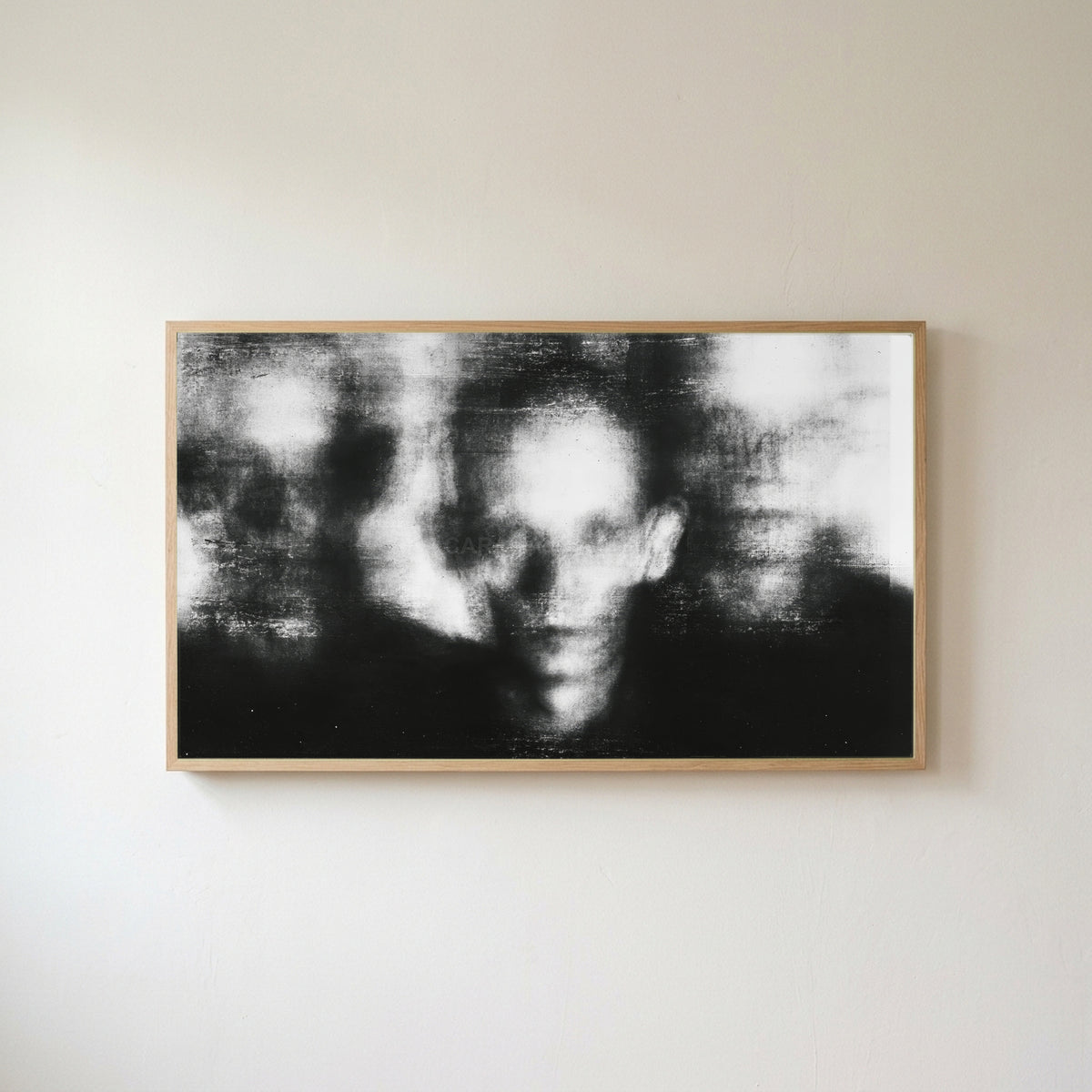 Blurred faces Frame TV art in an oak frame on a warm white wall