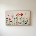 Embroidery style wildflower Frame TV art in an oak frame on a warm white wall