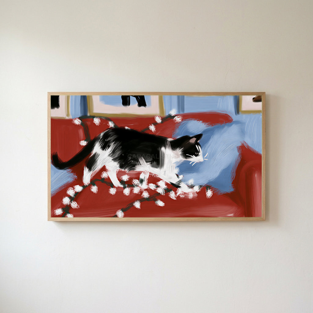 Black and white cat with Christmas lights Frame TV art in an oak frame on a warm white wall