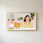 Woman at a pink table Frame TV art in an oak frame on a warm white wall